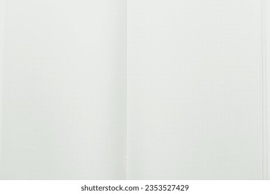 close up top view image of open notebook with blank page, spotted paper texture background