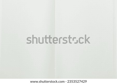 close up top view image of open notebook with blank page, spotted paper texture background