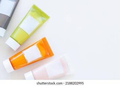 Close Up Top View Mock Up, Blank Label Facial Moisturiser, Take Care Of Clean Soft Skin Of The Body, Daily Cosmetic Product Skincare, Multi Colored Tube Bottle Product On White Background And Copy Or 