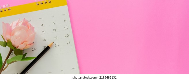 close up top view on calendar with glower and pencil to masking about menstruations period on pink color background for women health life concept - Shutterstock ID 2195492131