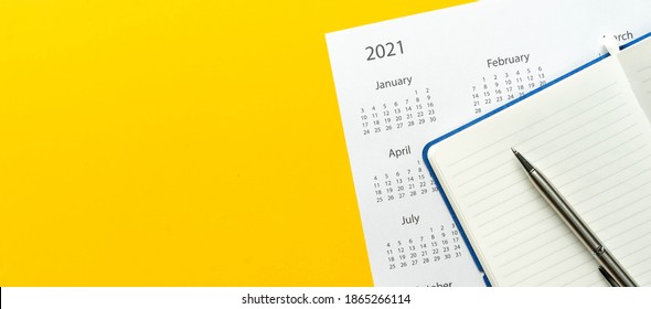 Close Up Top View On White Calendar 2021 Schedule With Blank Notebook Page And Pen On Yellow Color Background To Make Appointment Meeting Or Manage Timetable Each Day For Design Planning Work And Life