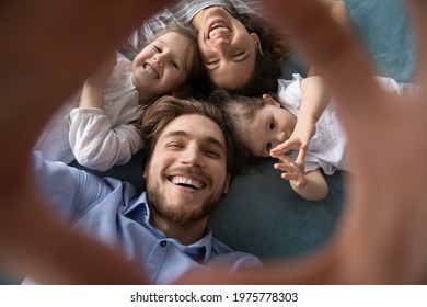 Close Up Top View Portrait Of Smiling Young Caucasian Family With Two Small Daughters Make Self-portrait Picture Together. Happy Parents Have Fun Relax Play With Little Girls Children, Make Selfie.