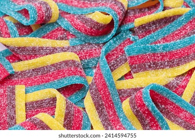 Close up top view of rainbow color sugar coated sour candy strips