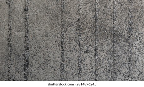Close up top view of rough grey concrete road surface texture with vertical lines for construction and background design