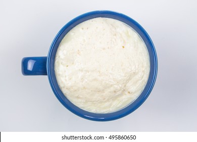 Close Up Top View Spoiled Milk In Blue Glass On White Background, Bad Milk, Concept Healthy 