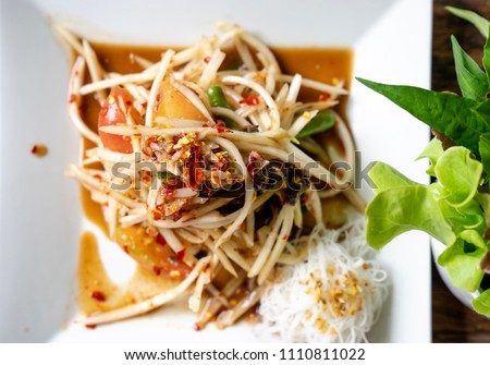 close up top view Thai Spicy Green Papaya Salad with pickled fish delicious Thai food Cuisine, Som Tum puu pla ra, close up