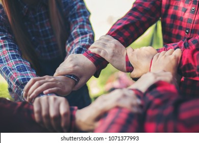 Close up top view of young business people putting their hands together. Unity and teamwork concept. - Shutterstock ID 1071377993