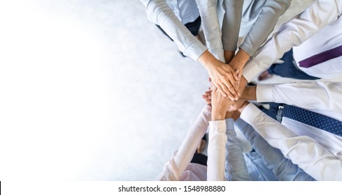 Close up top view of young business people putting their hands together. Stack of hands. Unity and teamwork concept. - Shutterstock ID 1548988880