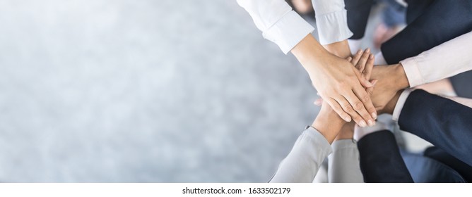 Close up top view of young business people putting their hands together. Stack of hands. Unity and teamwork concept. - Shutterstock ID 1633502179