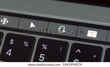 Close up of touch pad of a keyboard with only some of the keys in focus. Action. Symbols on a touch pad of a computer, concept of modern technologies.