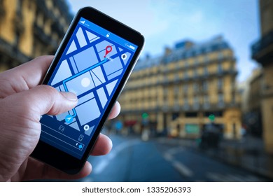 Close up of Tourist using GPS map navigation on smartphone application screen for direction to destination address in the city with travel and technology concept.     
