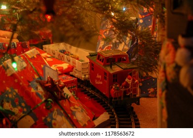 Close Up Of Toy Train Under Christmas Tree.