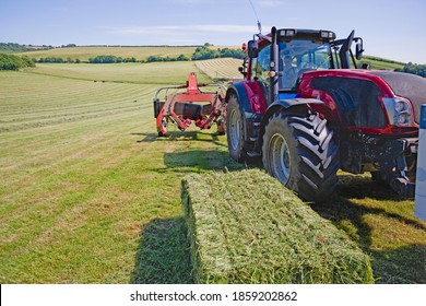 Close Up Of A Tractors And Bale Wrapper Baling Hay In The Field