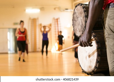 Close Up Of Traditional African Drum, View From Rear, Dance Class In Background