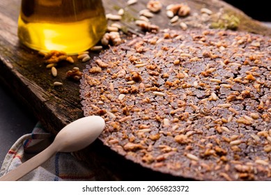 close up of traditional castagnaccio cake, a classic italian gluten free autumn cake on wooden table made with chestnuts flour, pine nuts, rosemary and olive oil. italian bakery and healthy food.