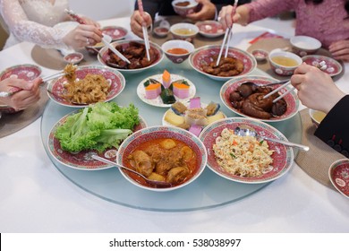Close Up Of Traditional Chinese Food With People Using Chopsticks As Background Soft Focus