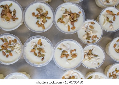 Close Up Of The Traditional Indian Yogurt Drink, Lassi, In Variable Cup Sizes At A Market Stall