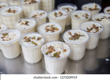 Close Up Of The Traditional Indian Yogurt Drink, Lassi, In Variable Cup Sizes At A Market Stall