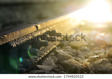 Close up of train railway steel track with head light of coming train
