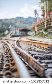 Close up train track with blurry background.