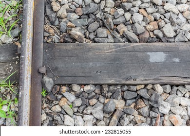 Close Up Of Train Track, Spike, And Wooden Railroad Tie .