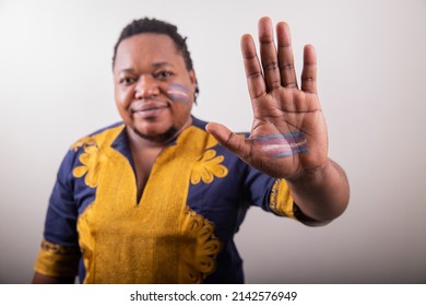 Close Up Of The Trans Flag Drawn On The Hand Of An African Trans Person. Studio Portrait, LGBT Community Rights