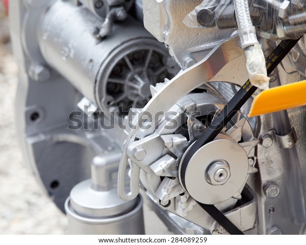Close up of\
transmission belt on car\
engine