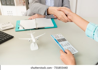 close up of travel agent company office worker with traveler customer handshake when they finished deal. selective focus photo.