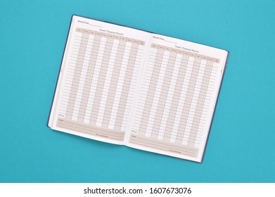 Close Up Of Travel Expense Report Book Open On Turquoise Background