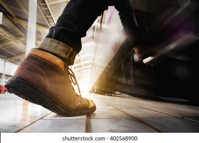 Close Up Of Traveler Feet Step Up To A Passing Train Vintage Tone. Travel Concept.