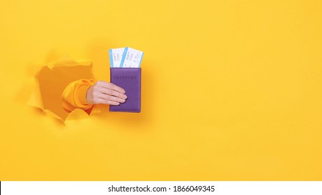 Close Up Traveler Tourist Man Woman Hands Hold Plane Passport Ticket Isolated Through Torn Yellow Background Studio. Passenger Traveling Abroad On Summer Weekends Getaway. Air Flight Journey Concept