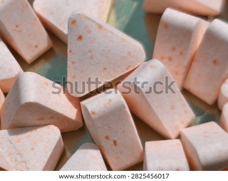 Close up of triangular chewable vitamin C tablets or supplement pills
