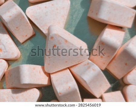 Close up of triangular chewable vitamin C tablets or supplement pills