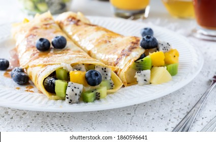 Close Up Of Tropical Fruit Crepes Filled With Mango, Dragon Fruit And Kiwi Ready For Eating.