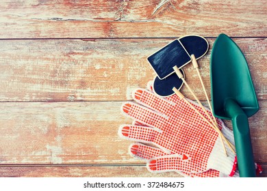 Close Up Of Trowel, Nameplates And Garden Gloves