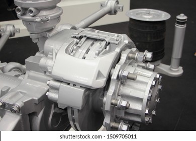 Close up truch wheel hub with brake disk, brake caliper levers and pneumatic suspension cylinder