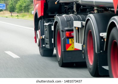 Close up of truck with red wheels driving on highway. - Shutterstock ID 1481073437