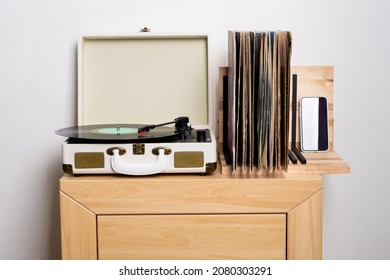 Close up of turntable and shelf with vinyl records