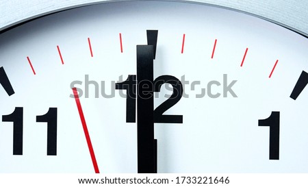 Close up Twelve o'clock Gray wall clock beginning of time 12.00 pm. , Concept It is 100 Seconds to Midnight.