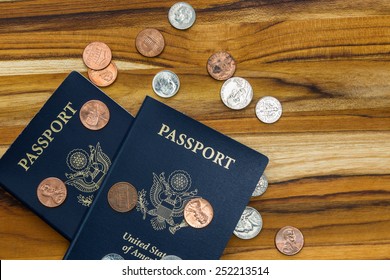 Close Up Of Two American Passports And Coins For A Cheap Travel Concept