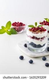 Close Up Of Two Blueberry And Pomegranate With Vanilla Greek Yogurt Breakfast Parfait.