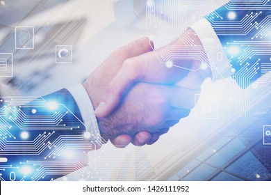 Close up of two businessmen shaking hands over blurred skyscraper background with double exposure of electronic brain hologram. Concept of AI and hi tech start up. Toned image