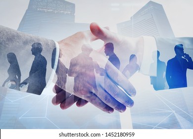 Close up of two businessmen shaking hands in modern city with double exposure of business people and network interface. Concept of connection and partnership. Toned image