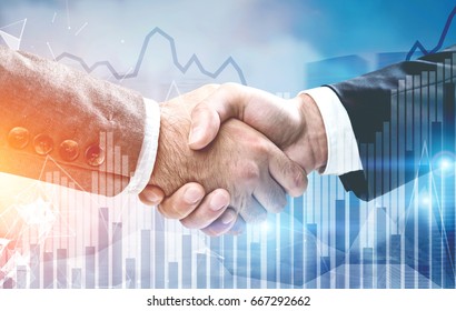 Close up of two businessmen shaking hands against a night cityscape. There are glowing graphs in the foreground. Toned image double exposure