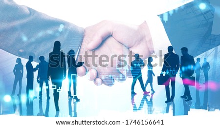 Close up of two businessmen shaking hands in blurry abstract city with their teammates in background and double exposure of financial chart. Concept of partnership. Toned image