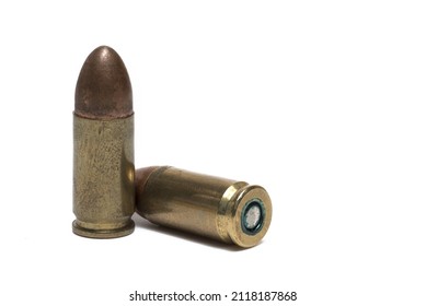 Close up of two cartridges with caliber nine millimeter as ammunition for pistols on white background