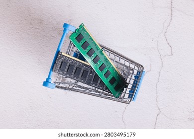 Close up of two computer memory modules in a shopping cart on a table top view