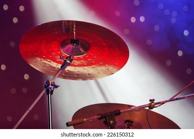 Close up of two drum plates isolated on stage with light show in the background  