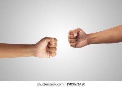 Close Up Of Two Fist Punching Each Other. Competition And Clash Concept. Isolated Image On Gray Background