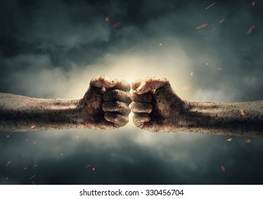 Close Up Of Two Fists Hitting Each Other Over Dramatic Sky Background